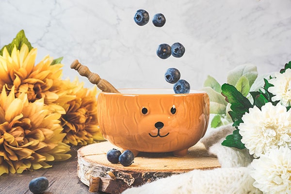 Blueberries pouring into a bowl